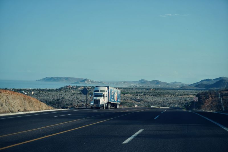 Flatbed truck preparing a vehicle for transport in Denver